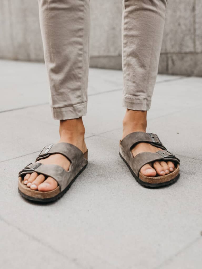 Close-up of a person wearing sandals.