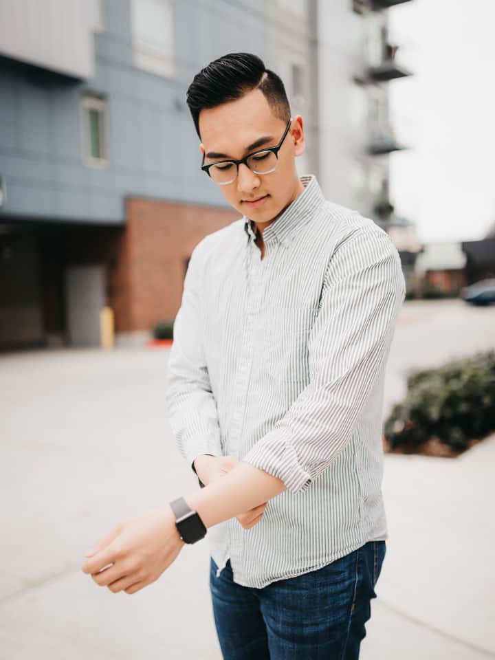 Person rolling their shirt sleeves.