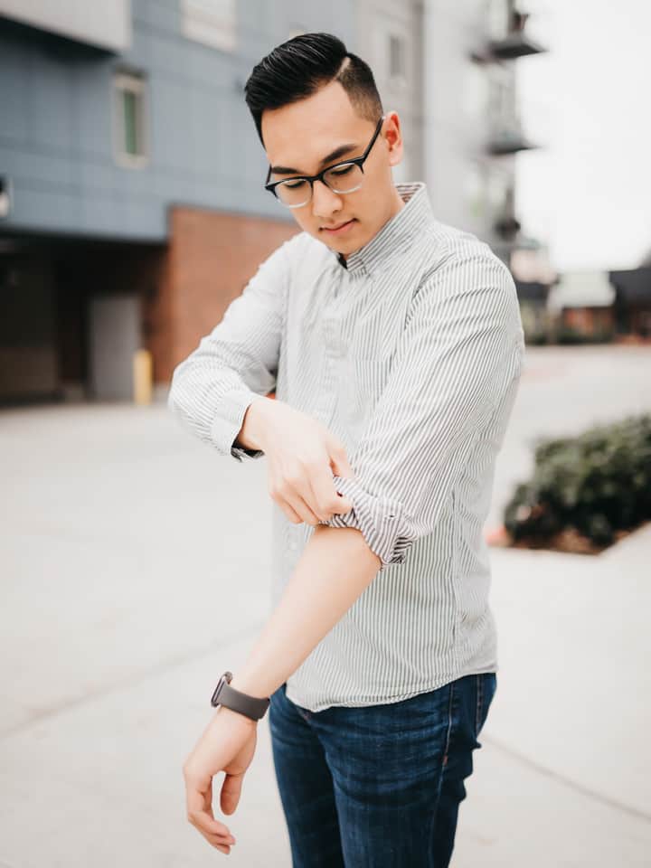 Person rolling their shirt sleeves.