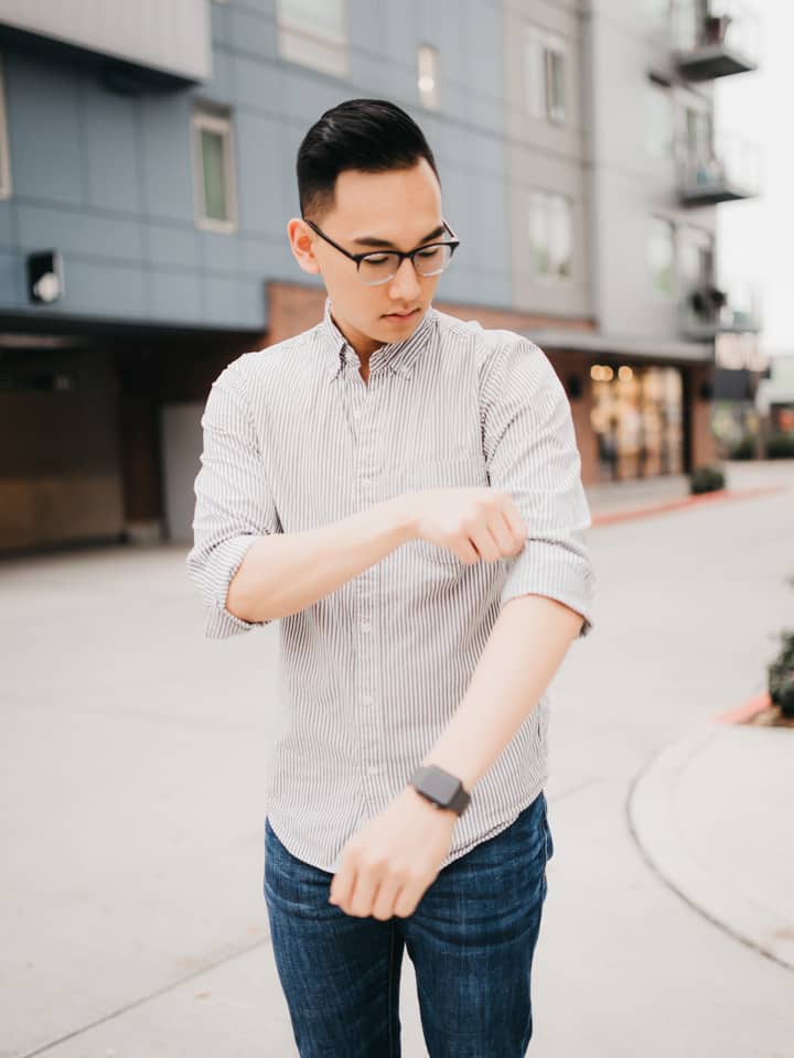 Person rolling their shirt sleeves.