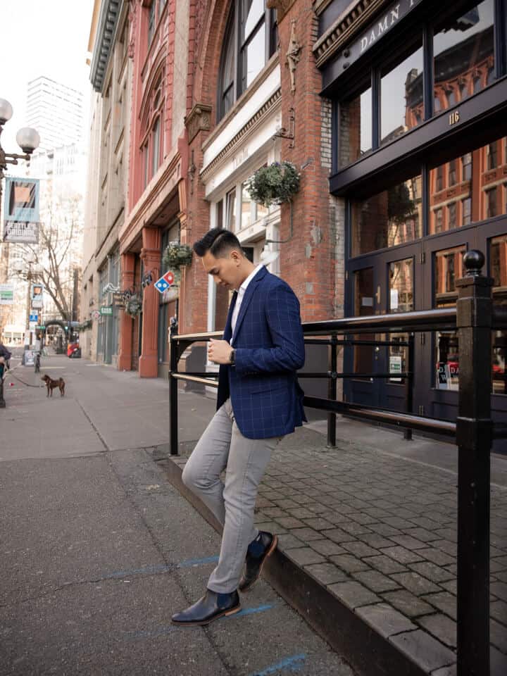 Person leaning against a railing in the city.