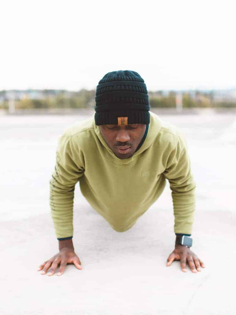 Man doing a push-up on cement.