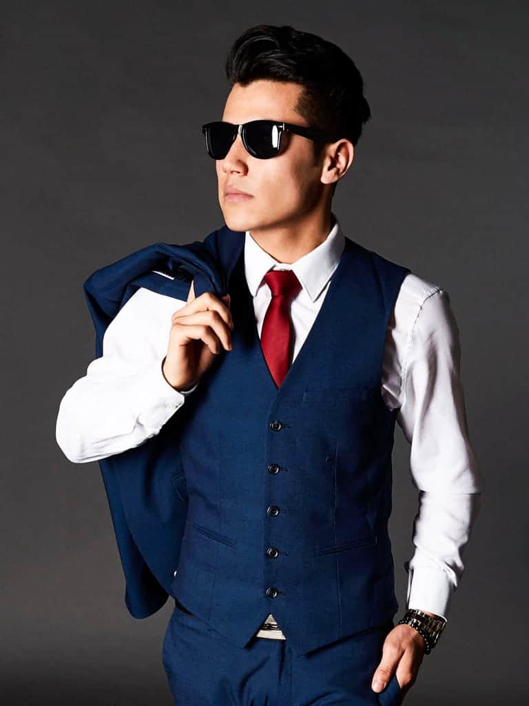 Person wearing a suit with sunglasses.