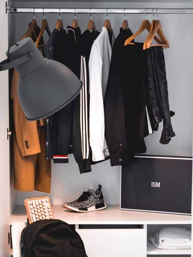 Minimal closet with clothes hanging.