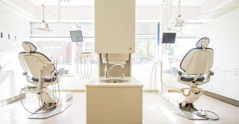 Two chairs in a dental office.