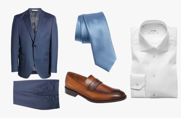 Blue suit, tie, white dress shirt, and brown penny loafer.