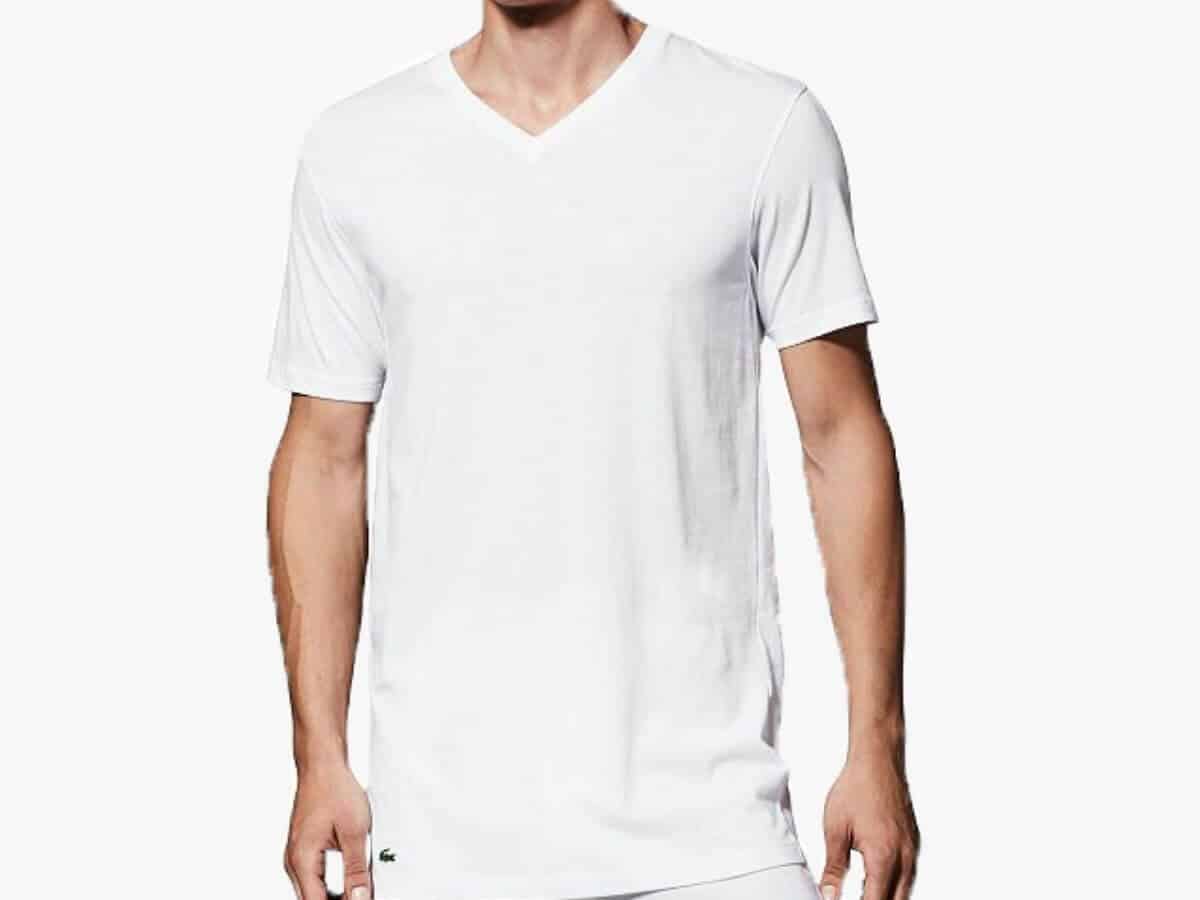 Person wearing a white Lacoste v-neck undershirt.