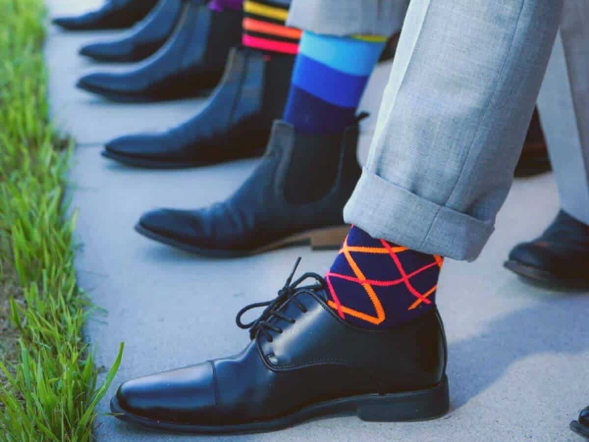 Close-up of people showing their socks.