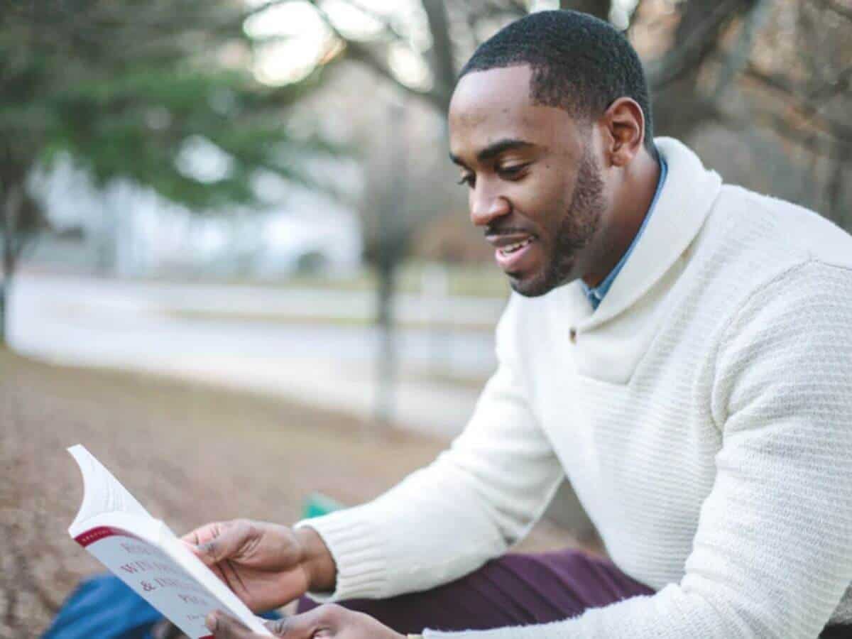 Person reading a book in the park.