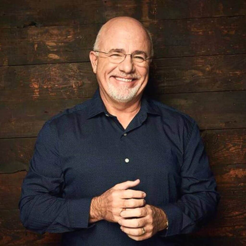 Dave Ramsey with a wooden background.