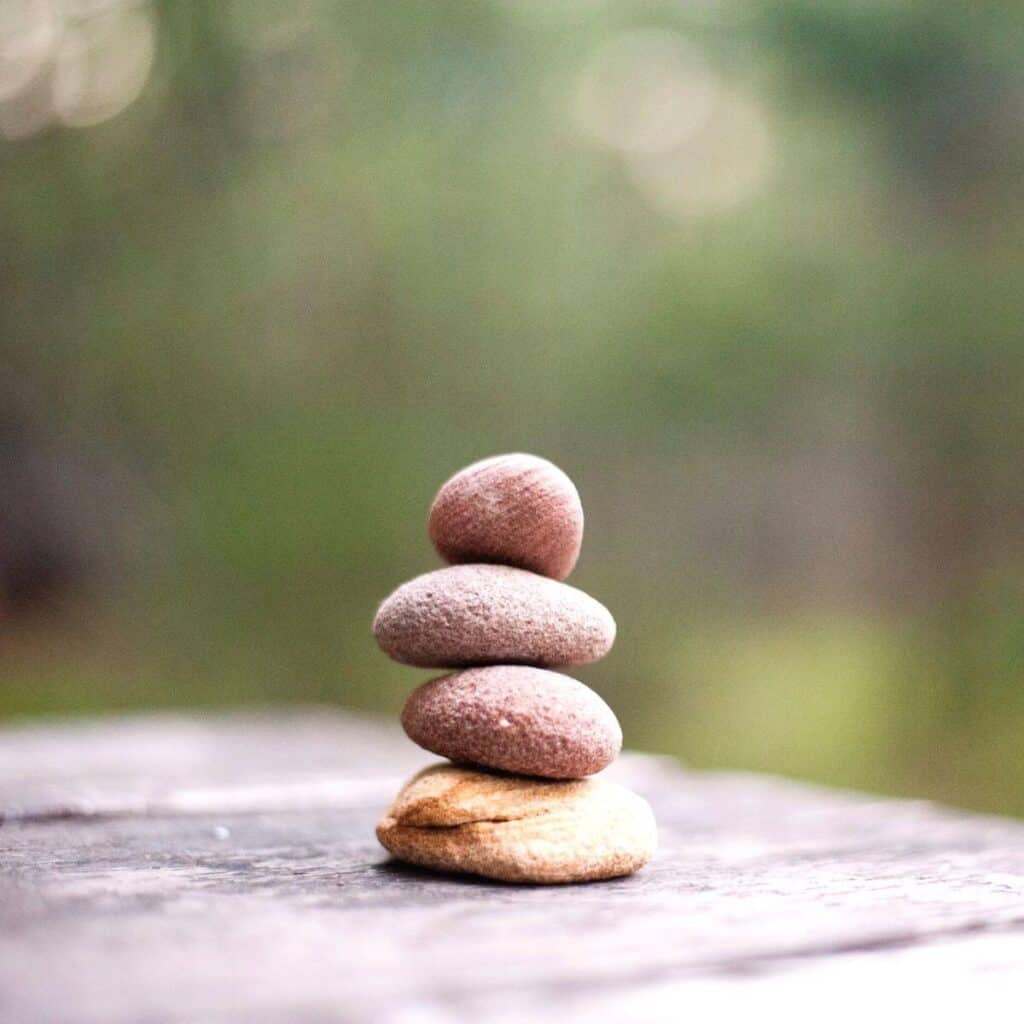 Four rocks stacked on a table.
