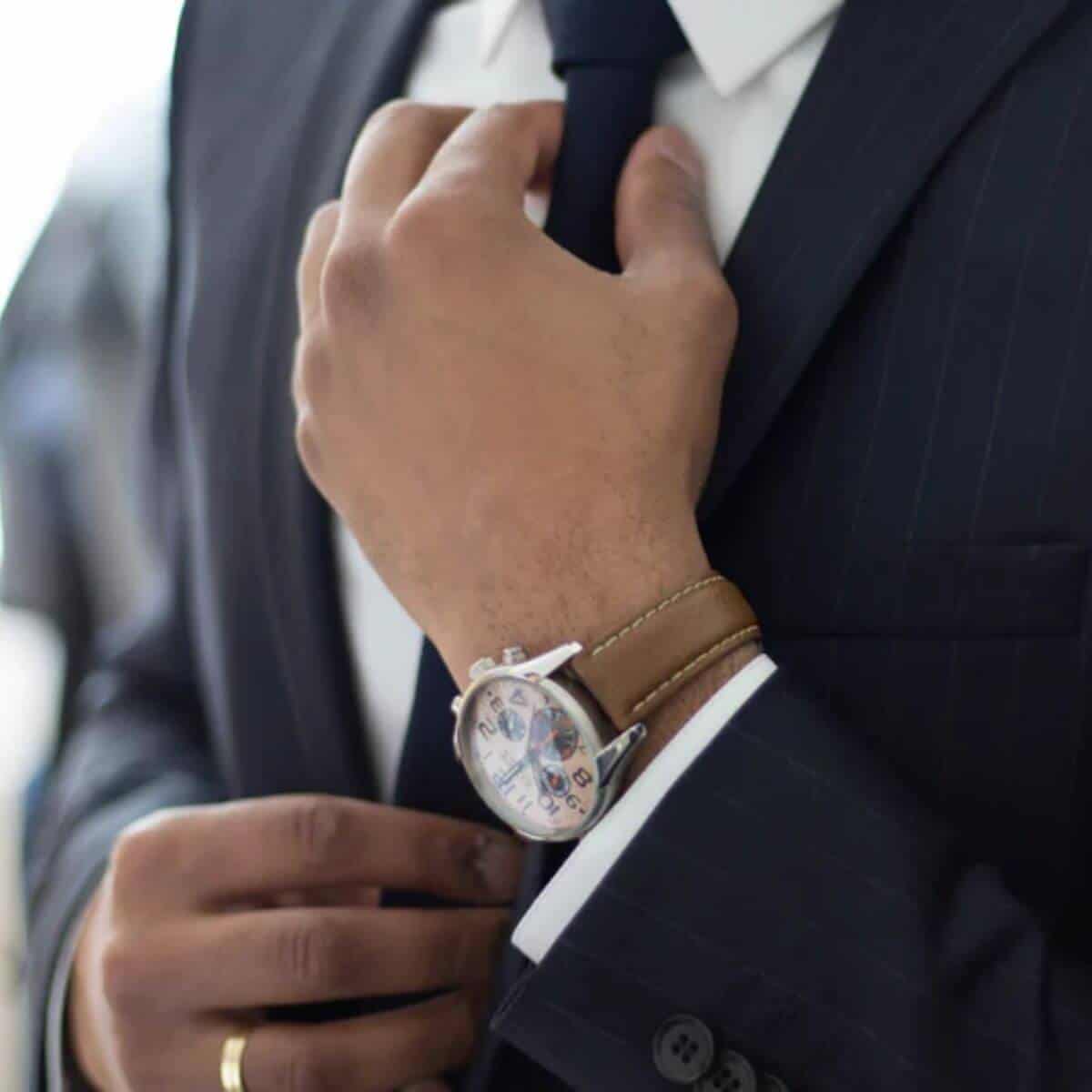 Close-up of a person fixing their tie