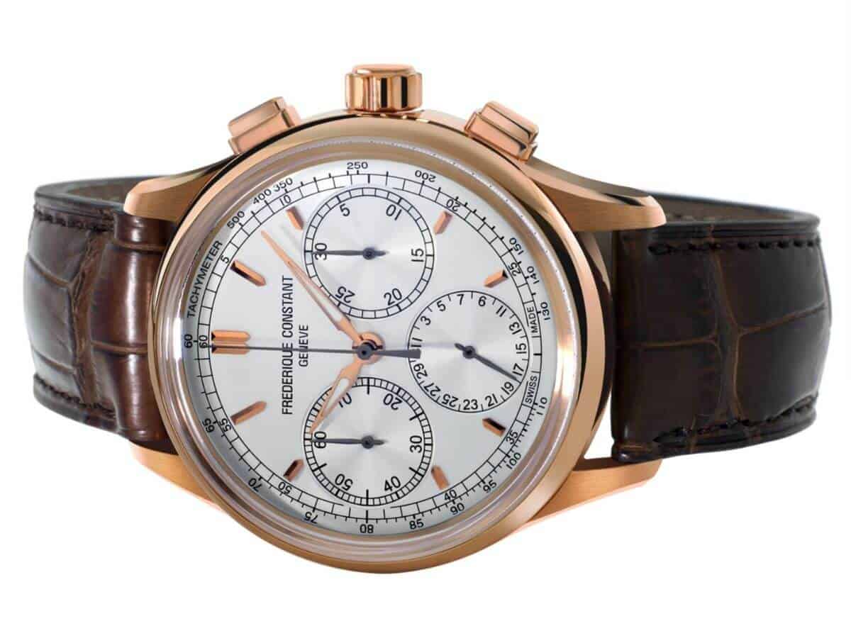 Frederique Constant chronograph watch with a gold case and brown leather strap.