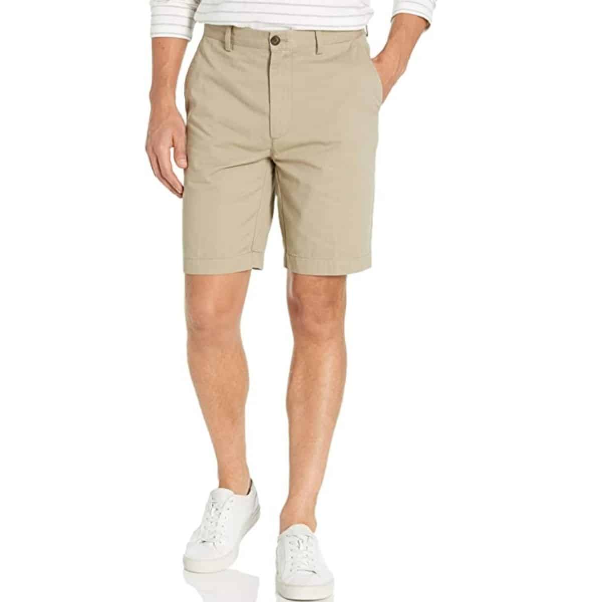 Bottom half of a person wearing shorts.