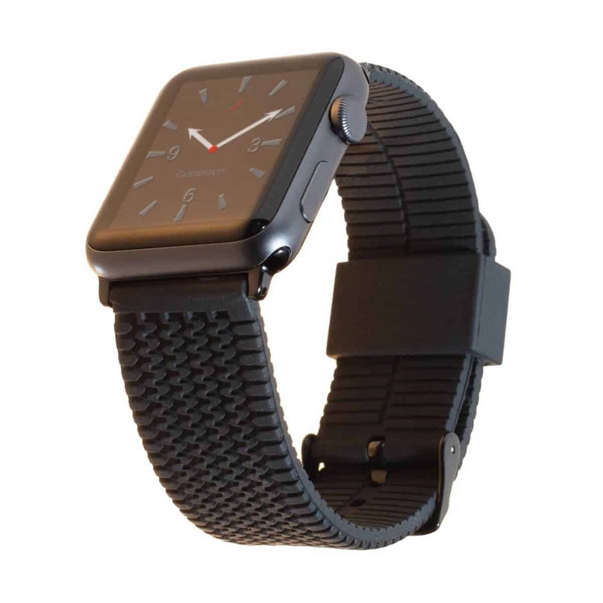 Apple Watch with a black silicone band that has a tire tread pattern.