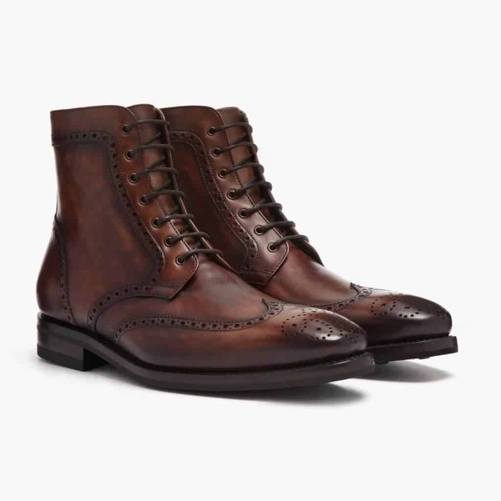 Dark brown wingtip lace-up boots.