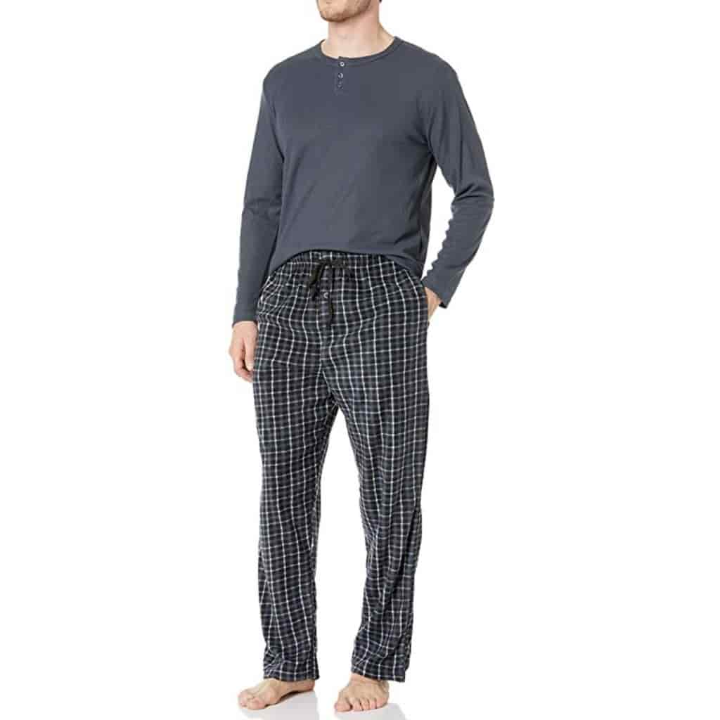 Person wearing a grey henley shirt and black plaid pajama pants.