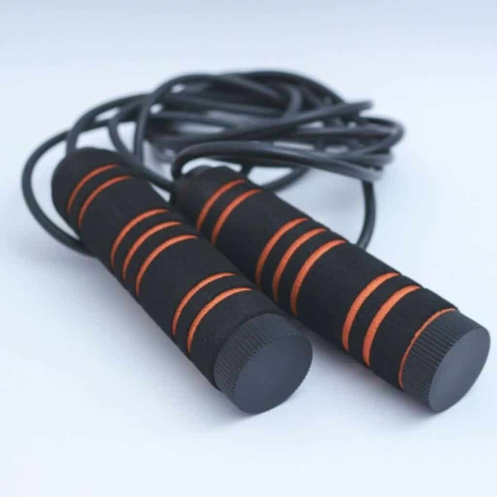 Jump rope with black and orange handles.