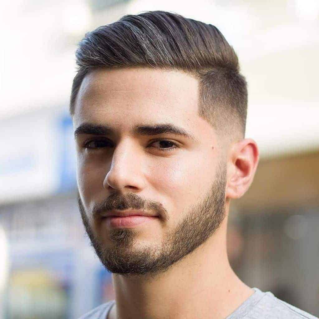 Headshot of a person with a comb-over haircut.