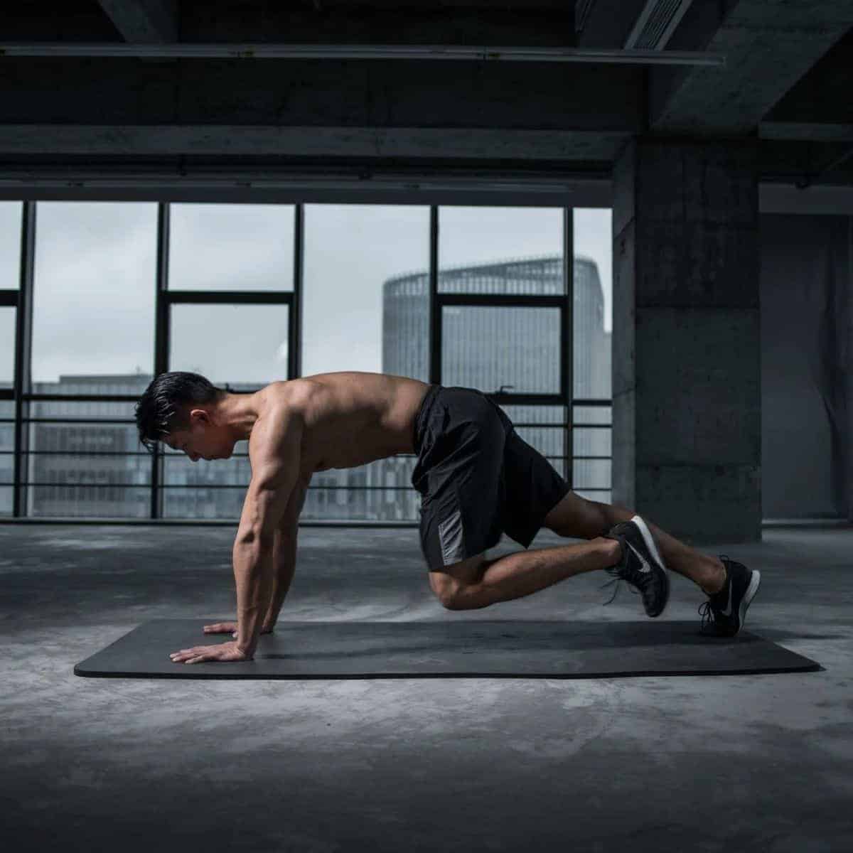 Person doing the mountain climbers exercise on a yoga mat.