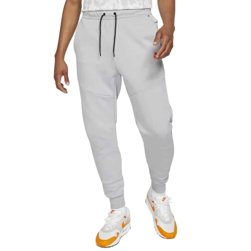 Lower half of a person wearing Nike fleece sweatpants.