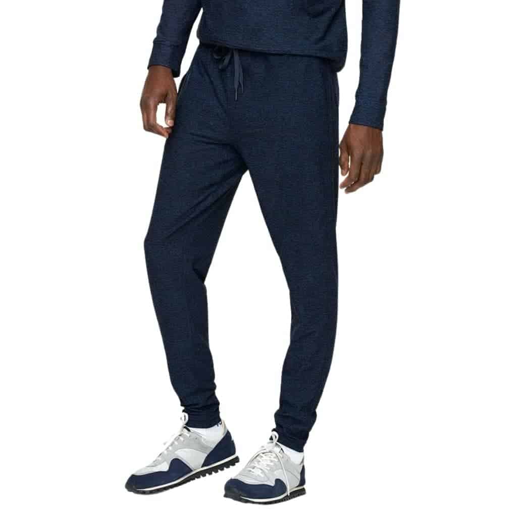 Lower half of a person wearing navy blue joggers.