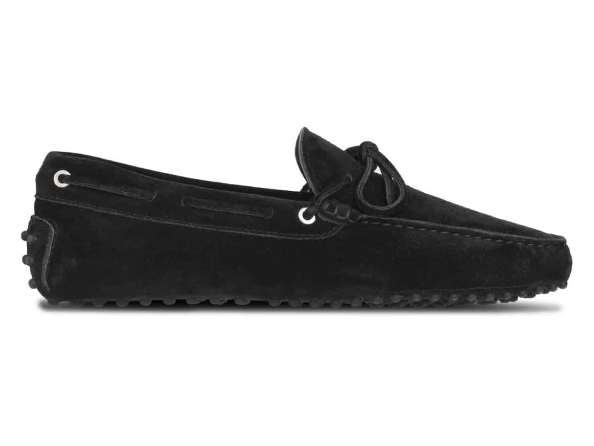 Side of a black suede driving shoe.