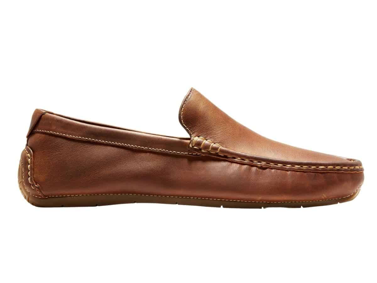 Side view of a brown leather driving shoe.