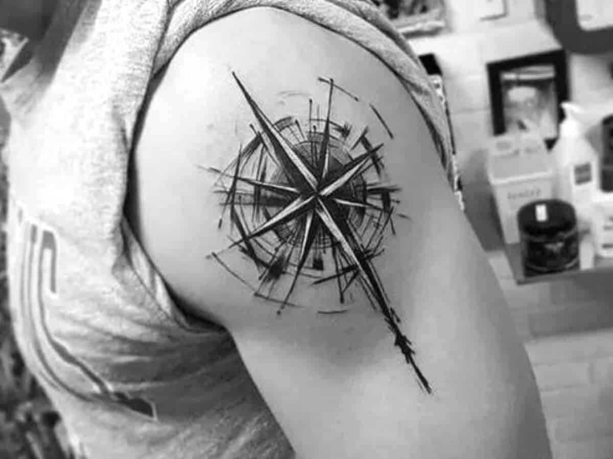 Compass tattoo on a person's shoulder.