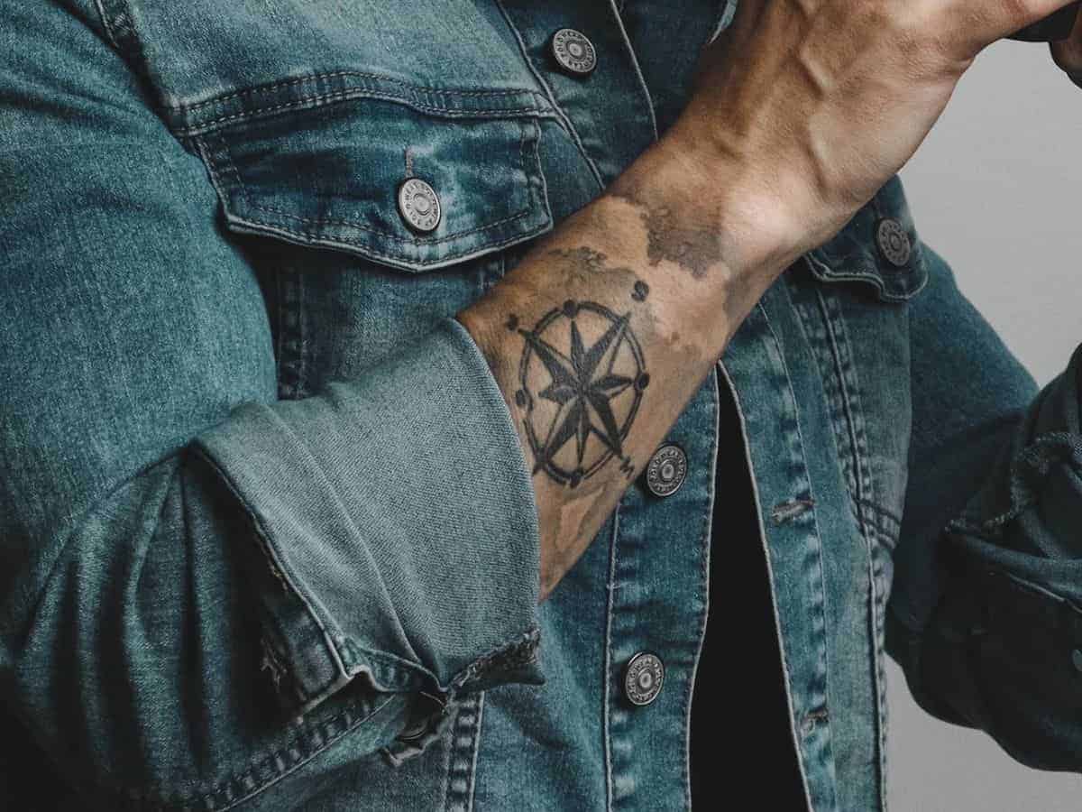 Compass tattoo on a person's arm.