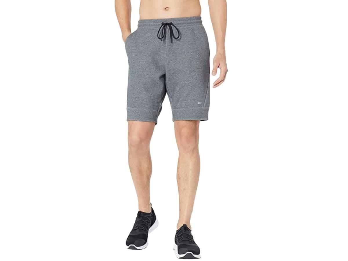 Lower half of a person wearing Amazon Essentials shorts.