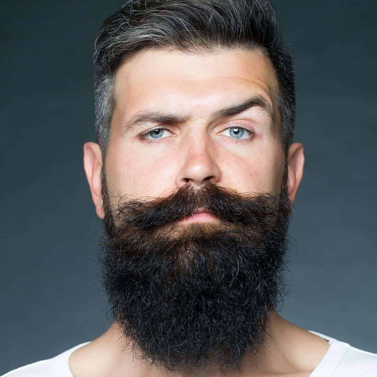 Person with a beard raising their eyebrow.