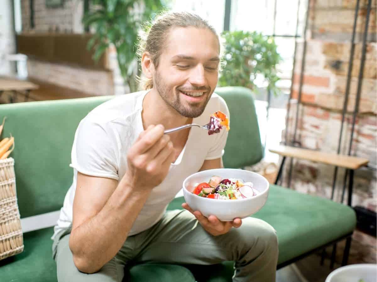 Person eating on a couch.