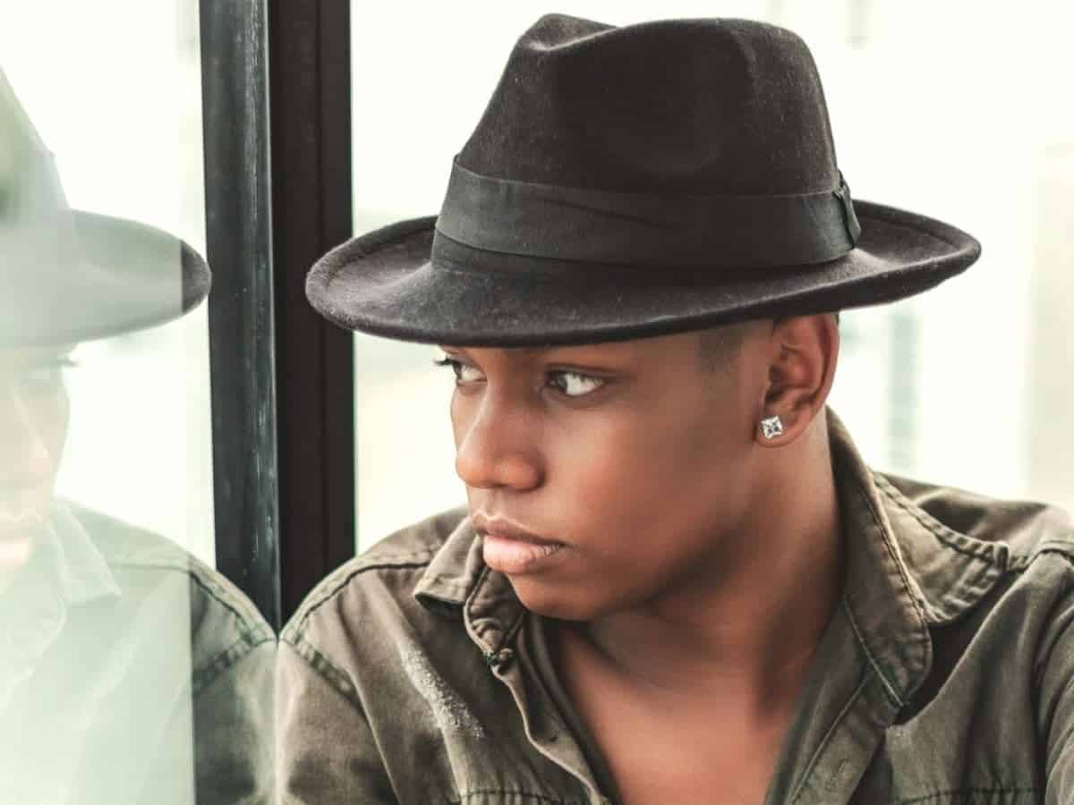 Person wearing a fedora and looking to the side.
