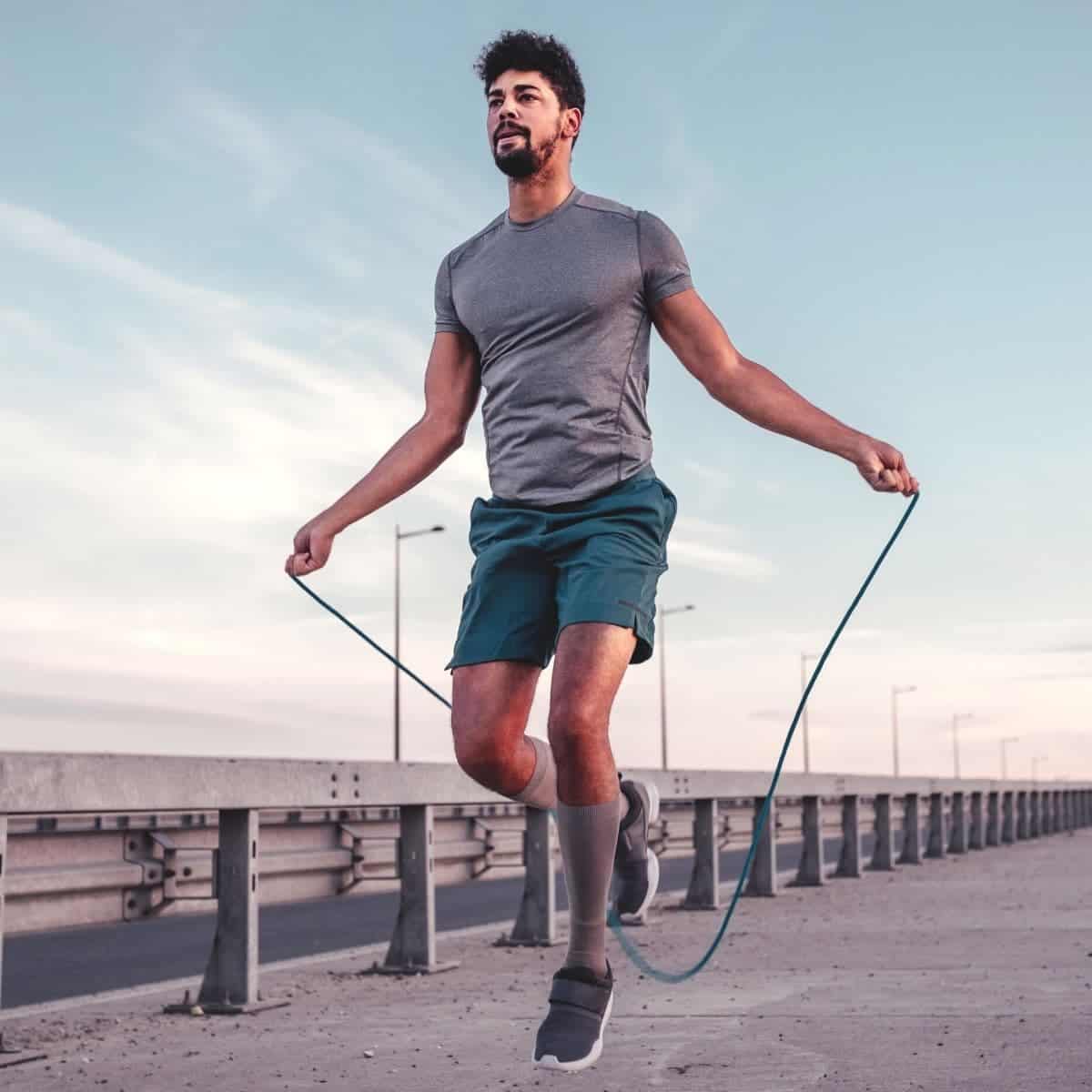 Person jumping rope on a sidewalk.