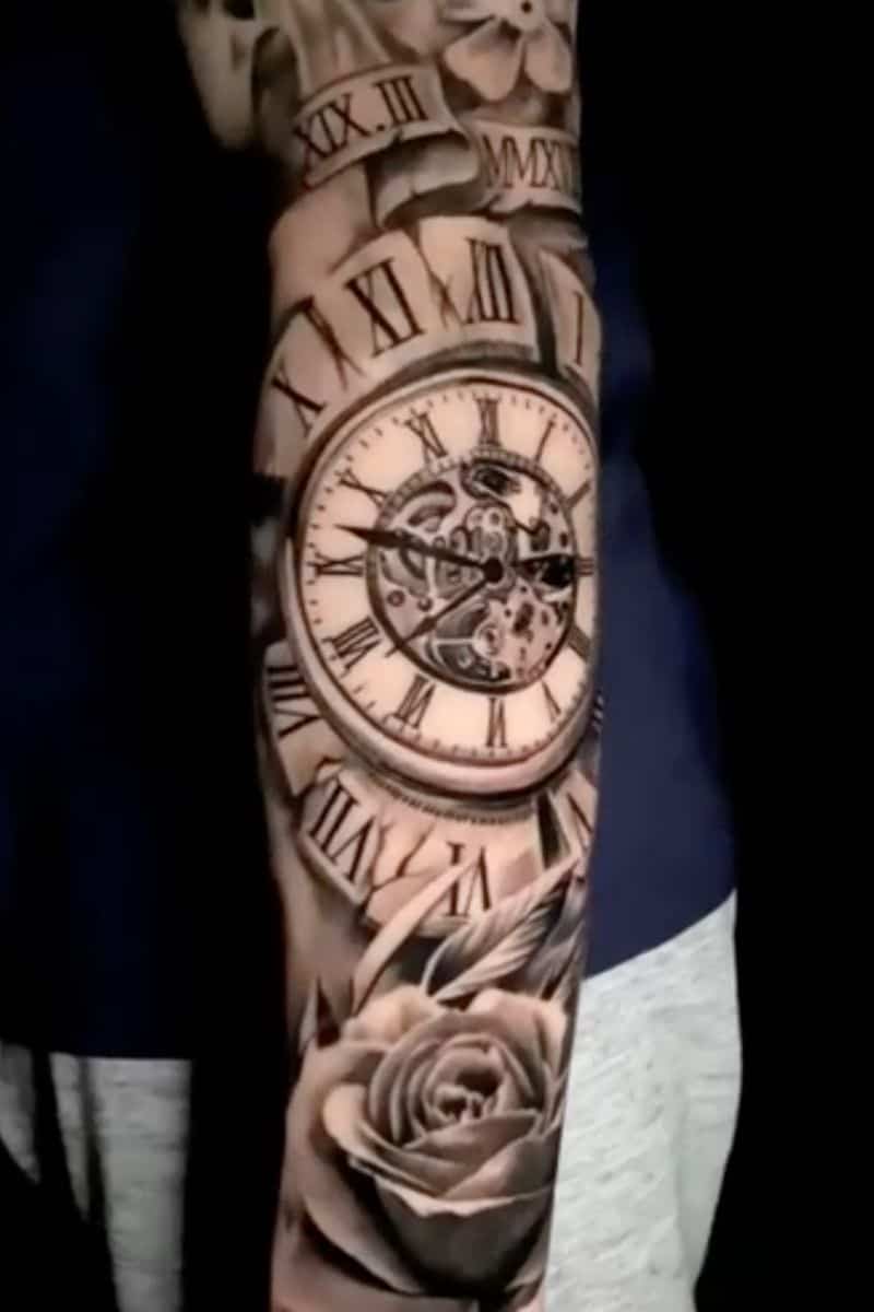 Person's arm with a tattoo of a clock and rose.