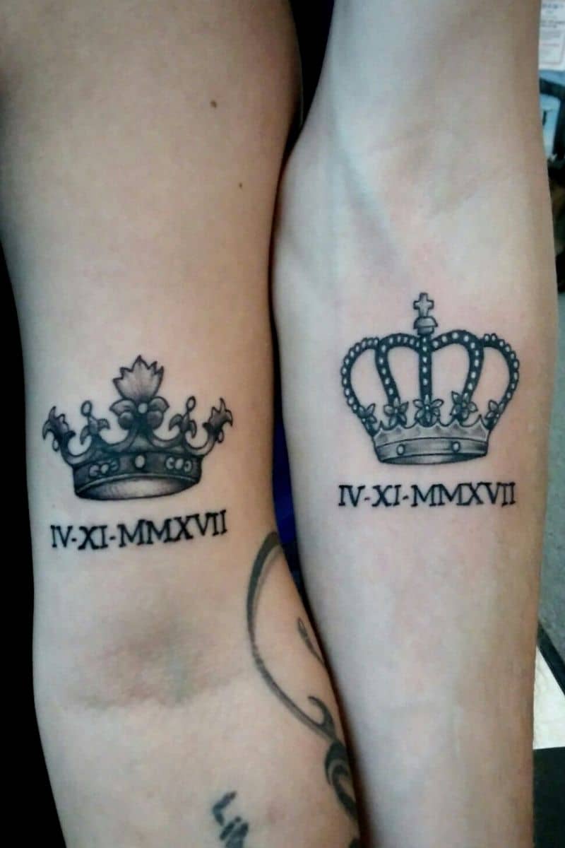 Two arms with a king and queen tattoo.