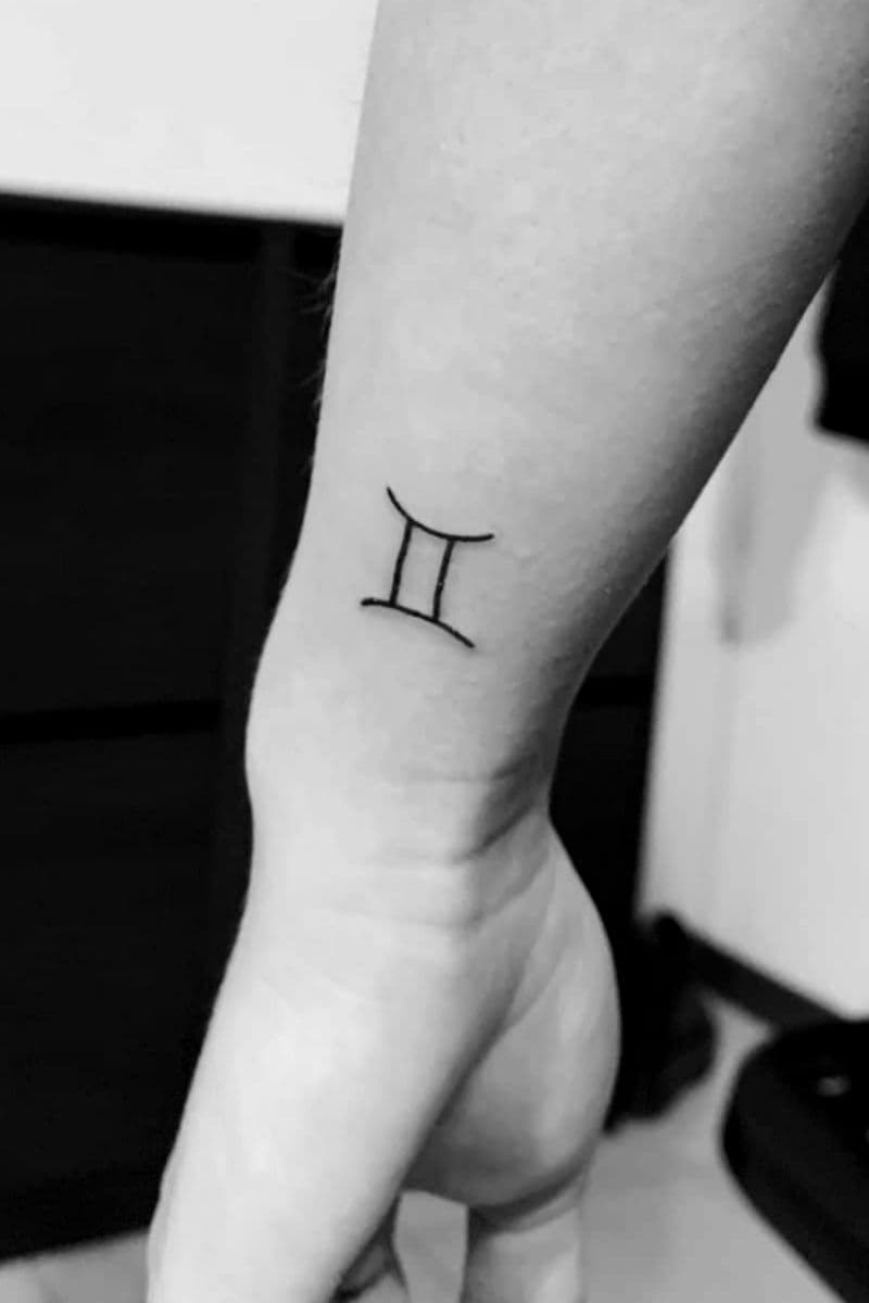 Gemini tattoo on a person's arm.