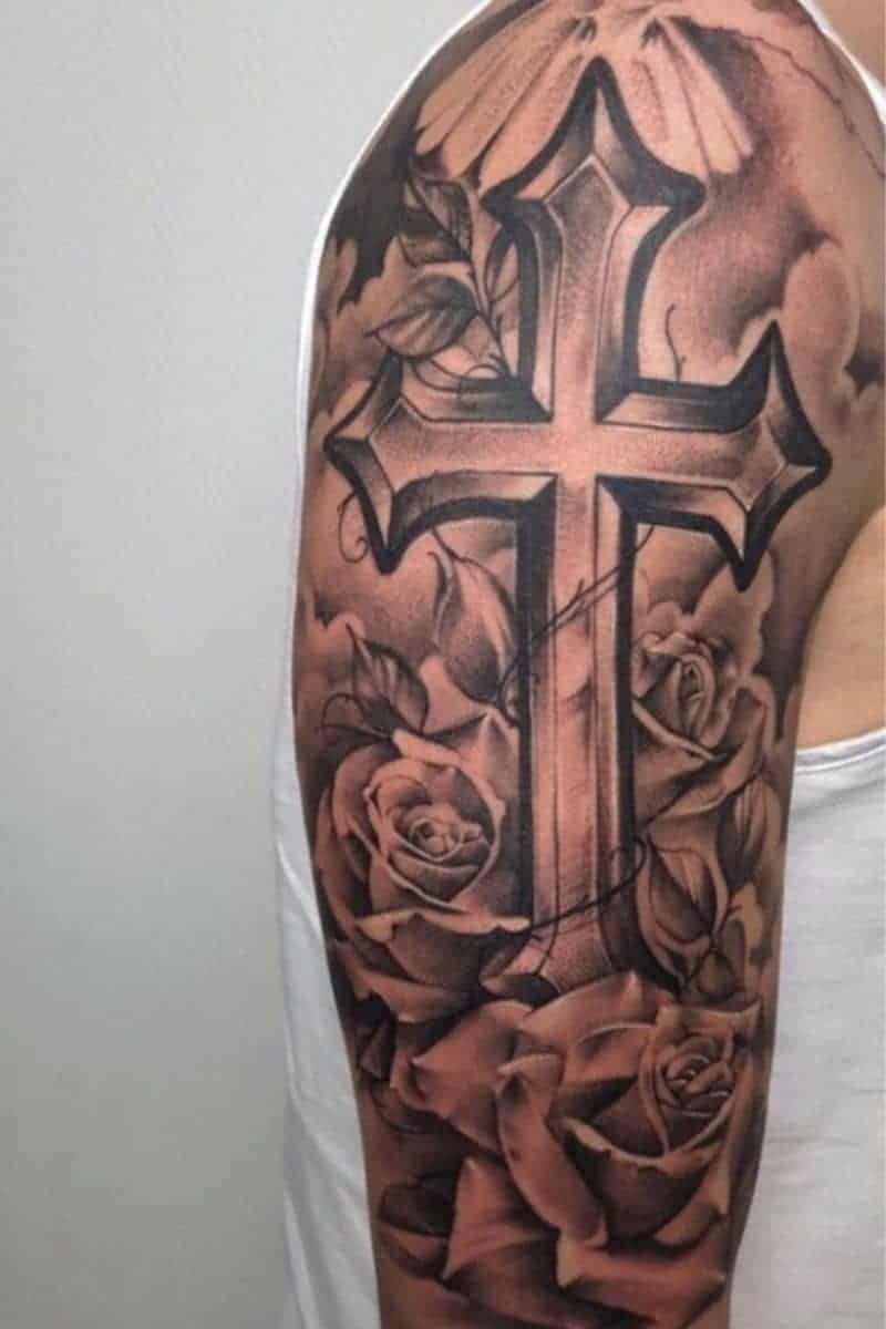 Cross and roses shoulder tattoo.
