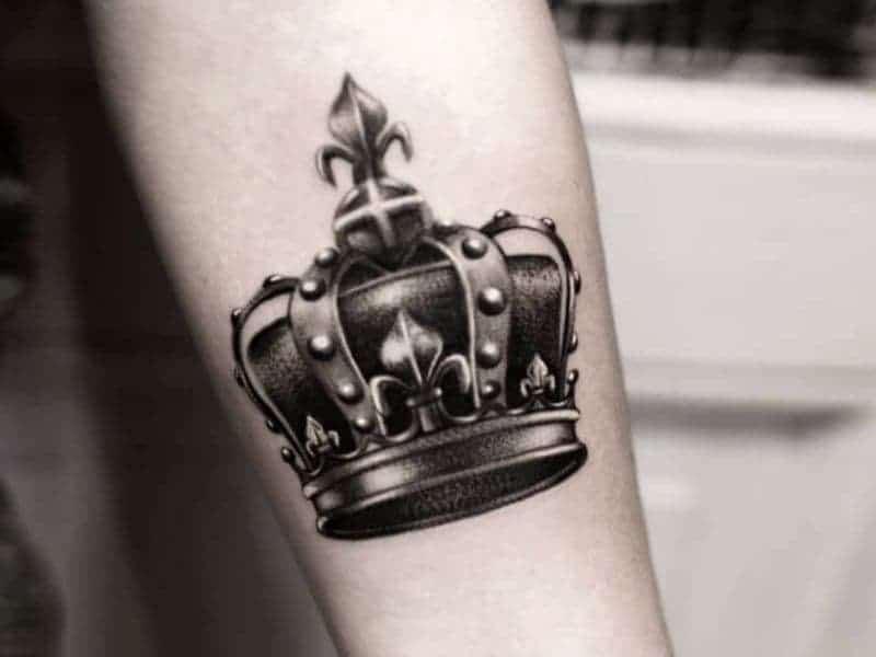 Crown tattoo on a person's forearm.
