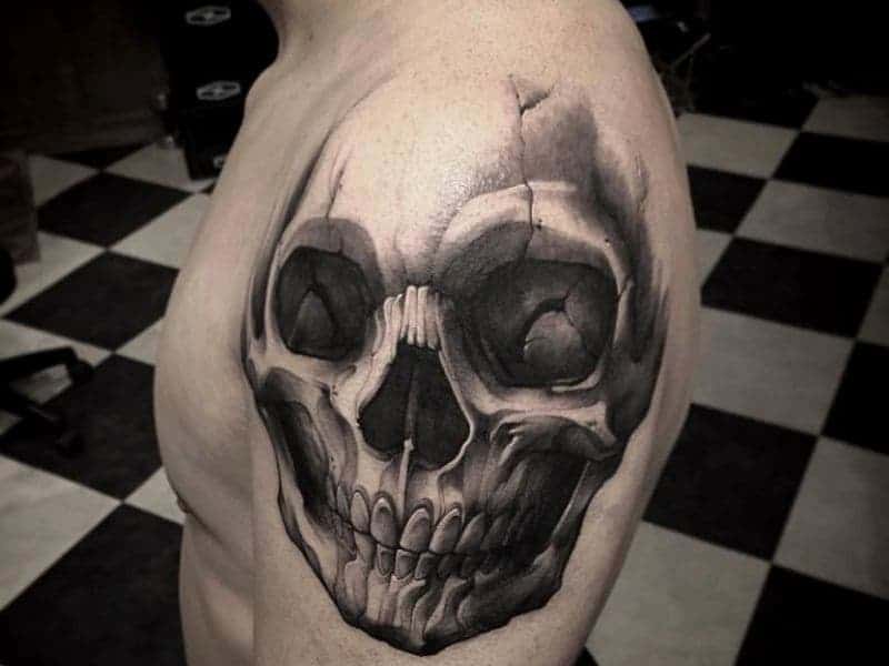 Person with a skull shoulder tattoo.