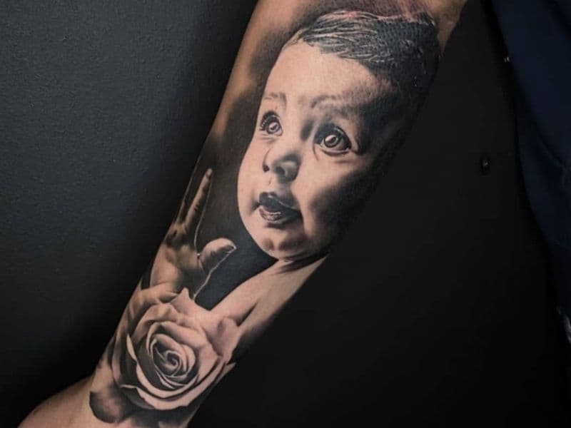 Portrait tattoo of a baby on a person's arm.