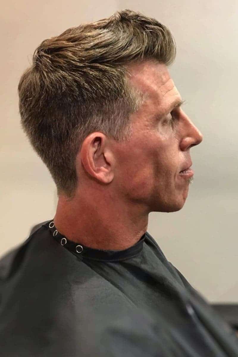 Side of a person's head with a faux hawk haircut.