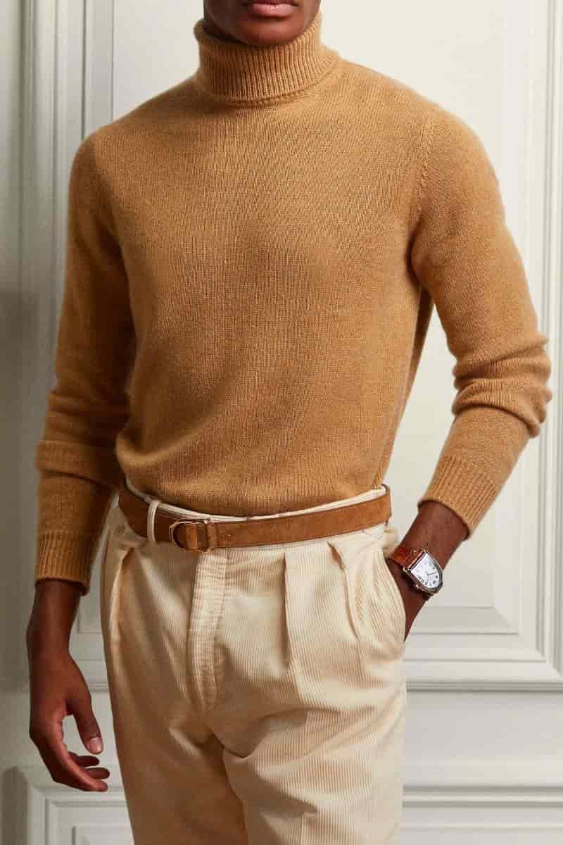 Person wearing a turtleneck sweater and corduroy pants.