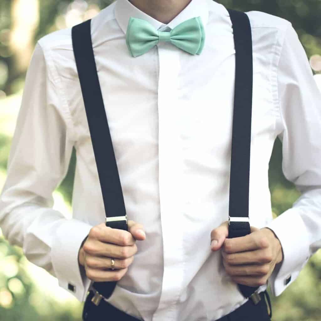 Person wearing suspenders and a bow tie.