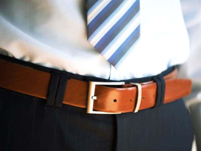 Leather belt around a person's waist.