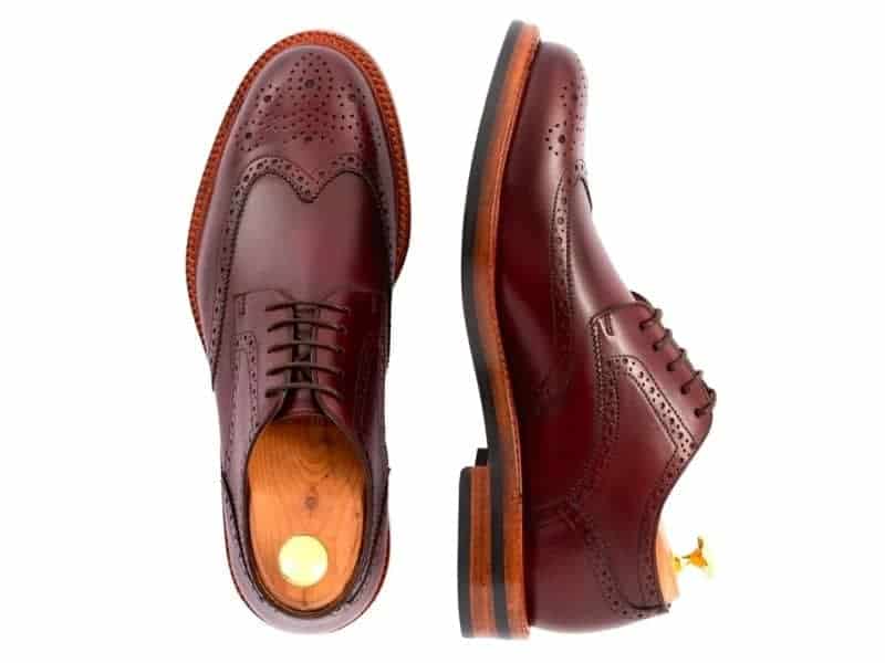 Pair of leather derby shoes with a wingtip design.