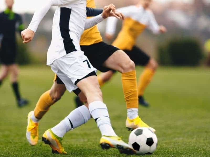 People playing soccer outdoors.