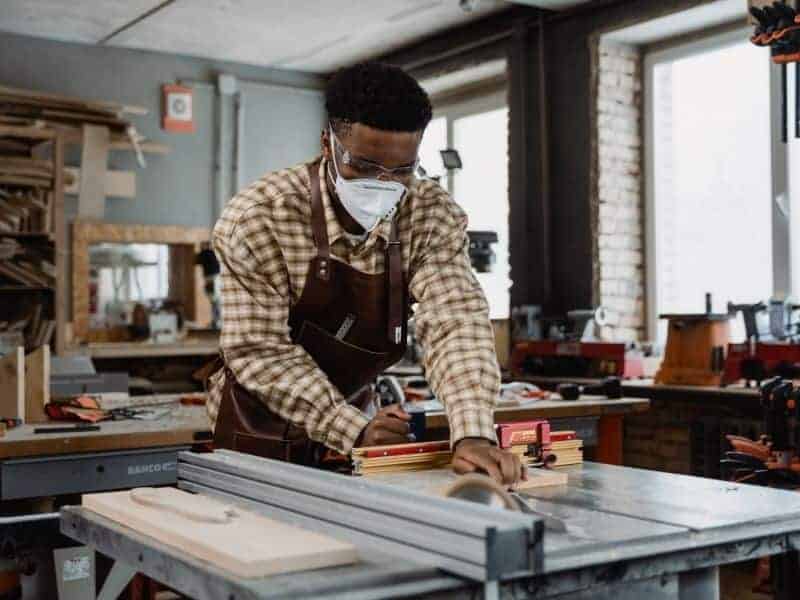 Person woodworking in a room.