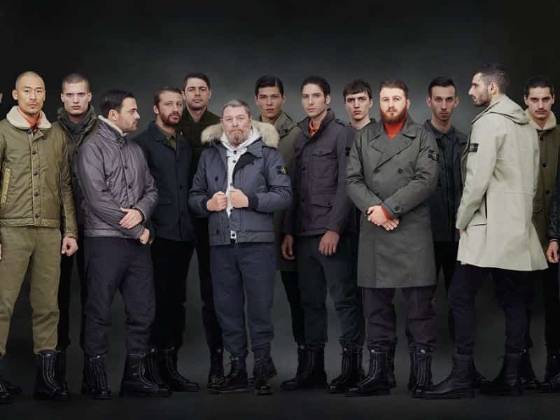 Group of men wearing outerwear and boots.
